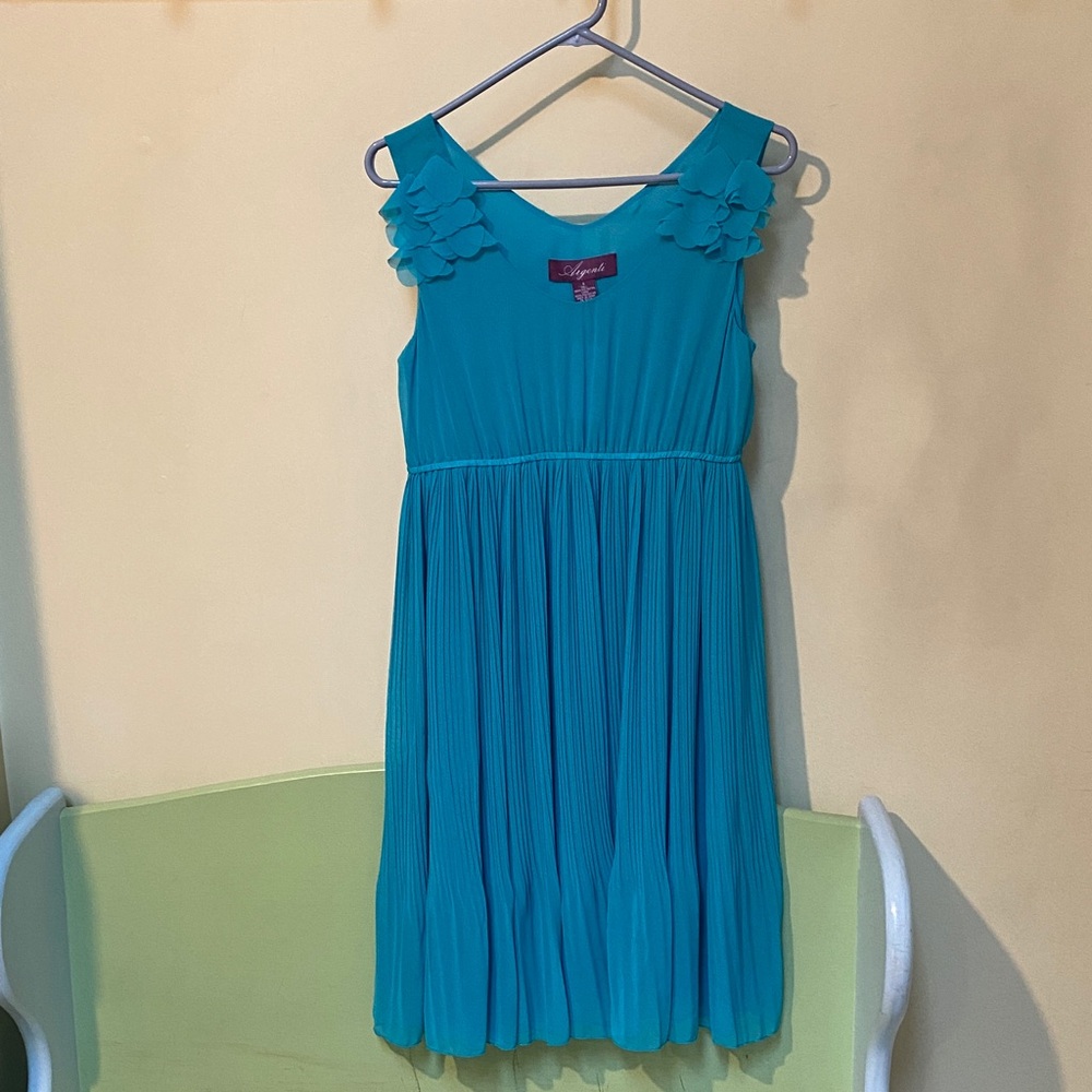 Turquoise ladies dress. 
Ruffles at shoulders. Plain back. Pleated skirt.